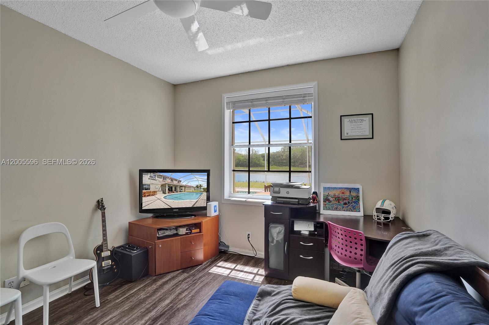 4281 Laurel Ridge Circle Weston, FL 33331 - Photo 35 of 80 a living room with furniture and a flat screen tv