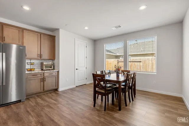 a kitchen with a table and refrigerator