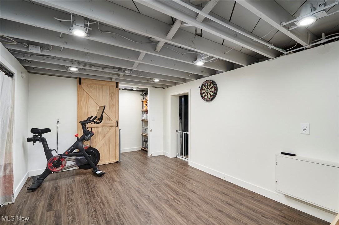 1847 Stabler Road Akron, OH 44313 - Photo 21 of 26 Exercise room with hardwood / wood-style floors and a barn door