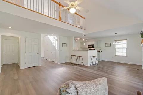 a view of a kitchen with furniture and wooden floor