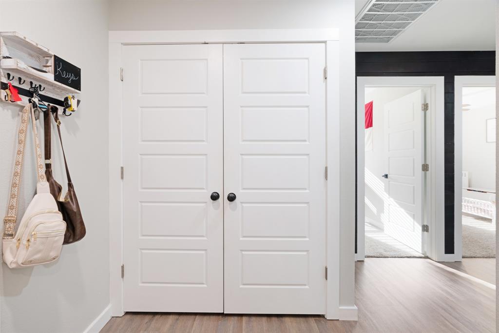 324 Private Road Paris, TX 75462 - Photo 11 of 15 a view of walk in closet with clothes and white wooden floor