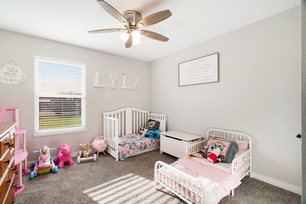 324 Private Road Paris, TX 75462 - Photo 12 of 15 a bedroom with furniture and a chandelier fan