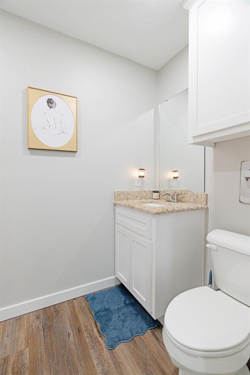 324 Private Road Paris, TX 75462 - Photo 13 of 15 a bathroom with a granite countertop toilet and a sink