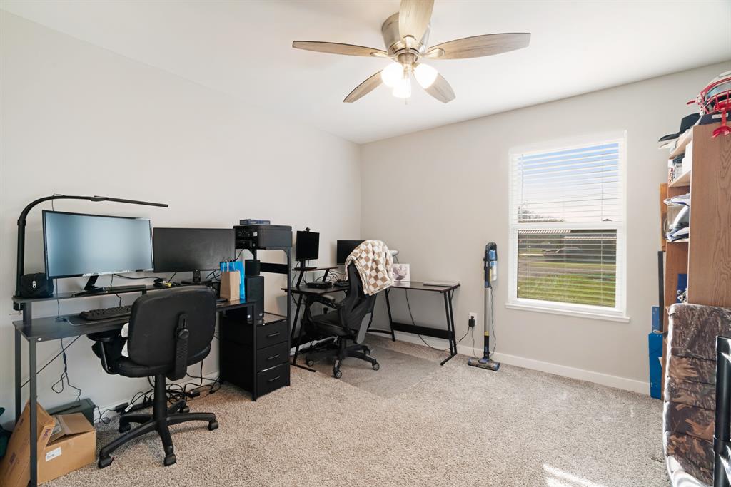 324 Private Road Paris, TX 75462 - Photo 8 of 15 a view of a workspace with furniture and a window