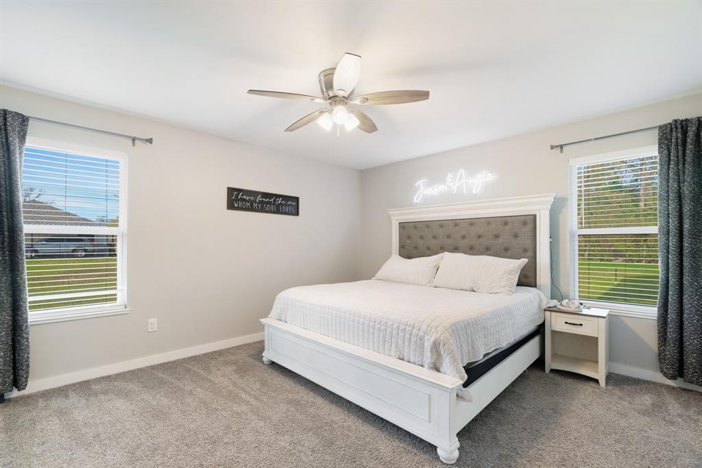 324 Private Road Paris, TX 75462 - Photo 9 of 15 a bedroom with a bed lamp and a window