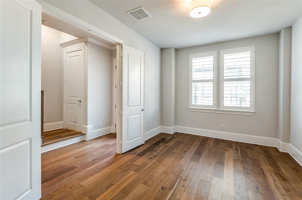 5421 Patterson Street Irving, TX 75039 - Photo 12 of 32 Room featuring wood-finish flooring, white plantation shutters, a semi-flush ceiling light fixture, and white painted trim
