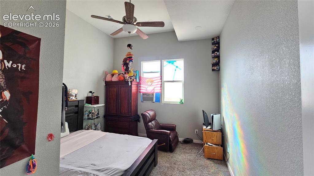 3835 Sengbeil Road Yoder, CO 80864 - Photo 19 of 48 a room with furniture a chandelier fan and a window