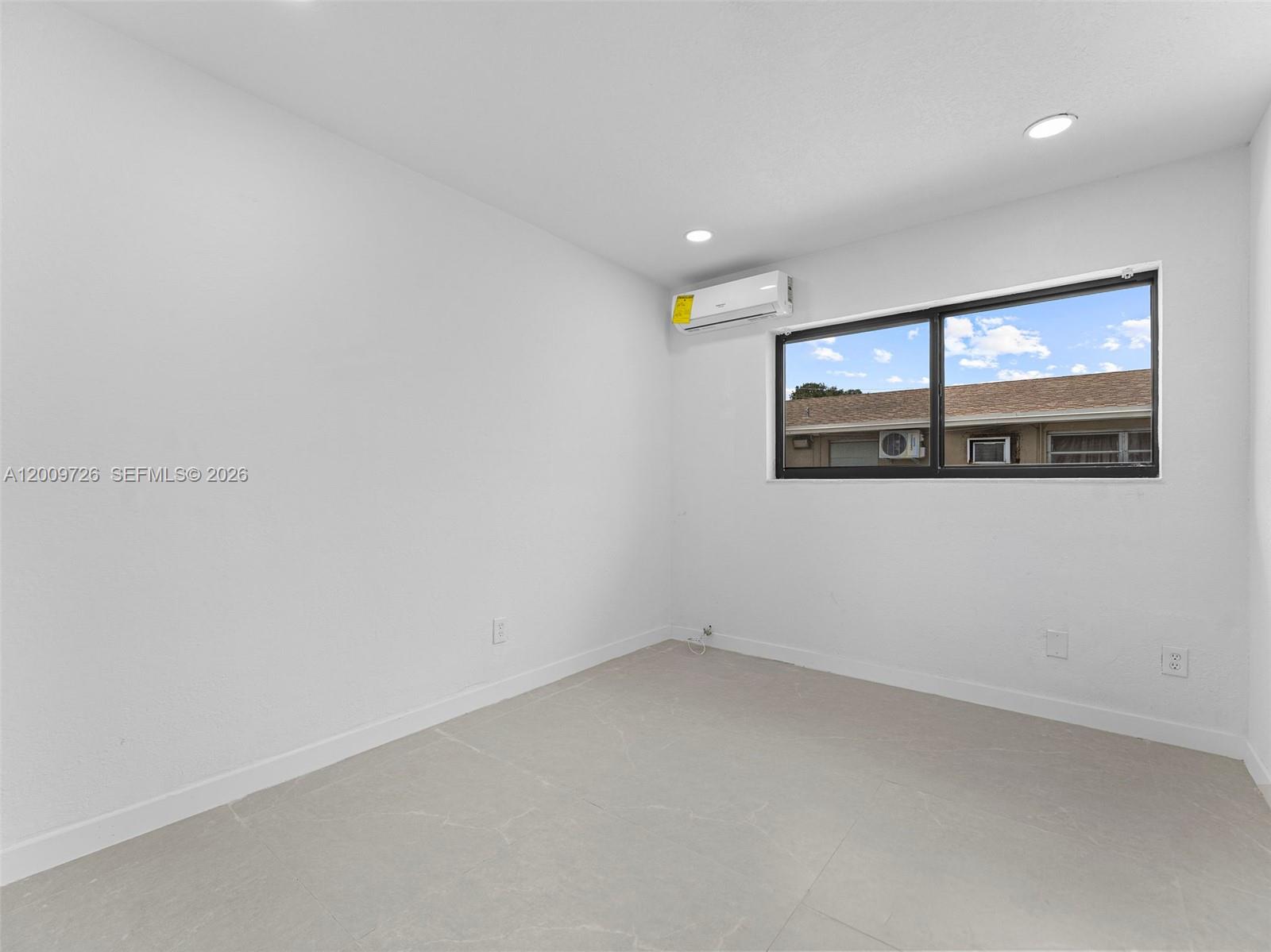 1370 West 29th Street, Unit A Hialeah, FL 33012 - Photo 13 of 16 an empty room with a window
