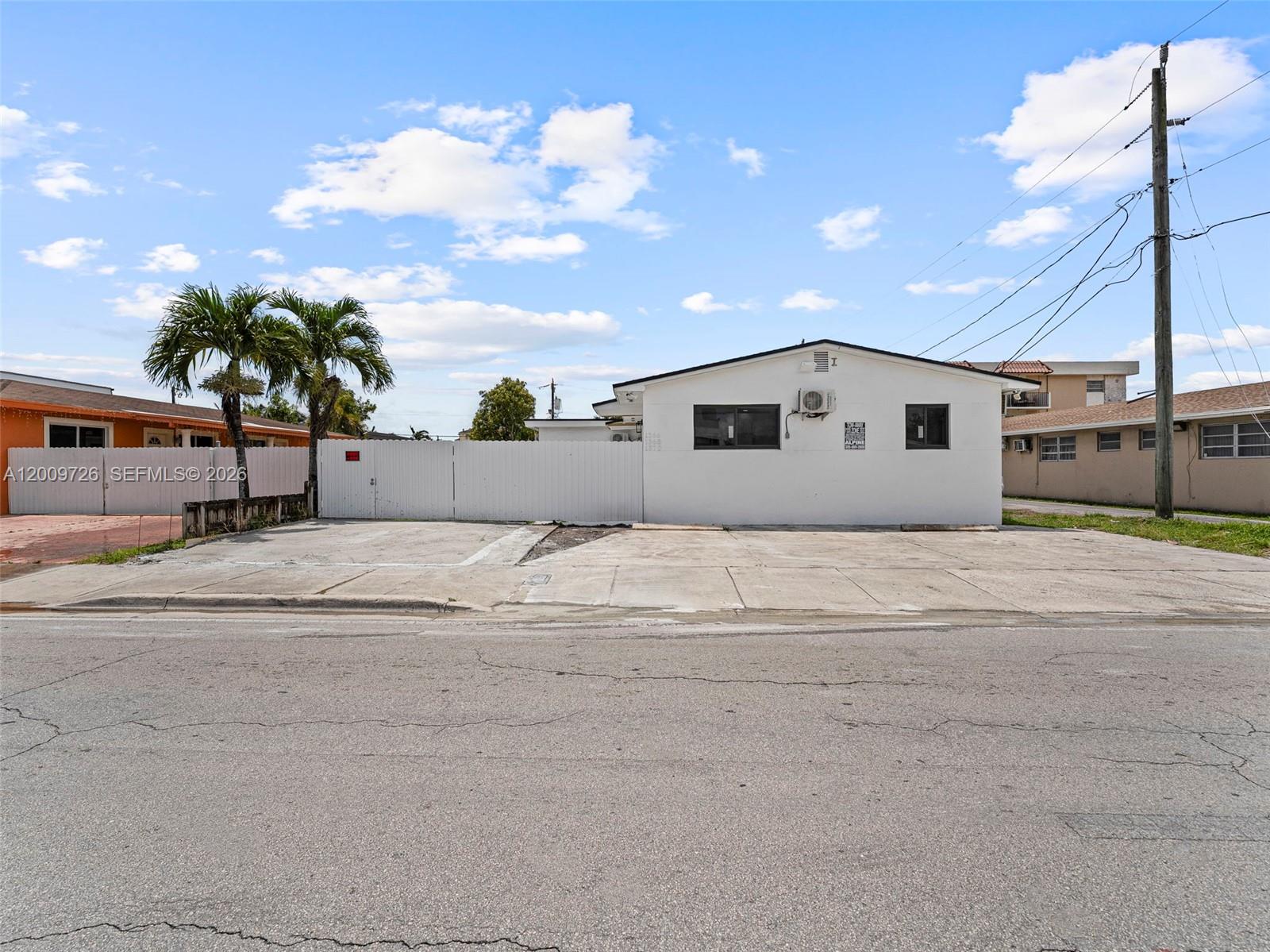 1370 West 29th Street, Unit A Hialeah, FL 33012 - Photo 2 of 16 a view of a white house with a yard