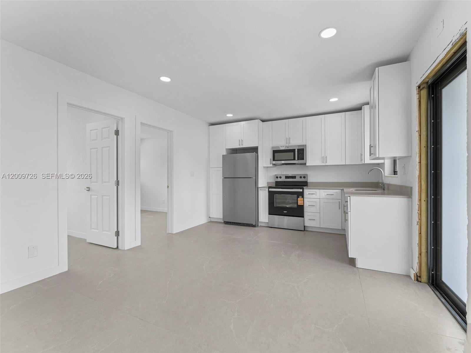 1370 West 29th Street, Unit A Hialeah, FL 33012 - Photo 8 of 16 a view of kitchen with refrigerator and microwave