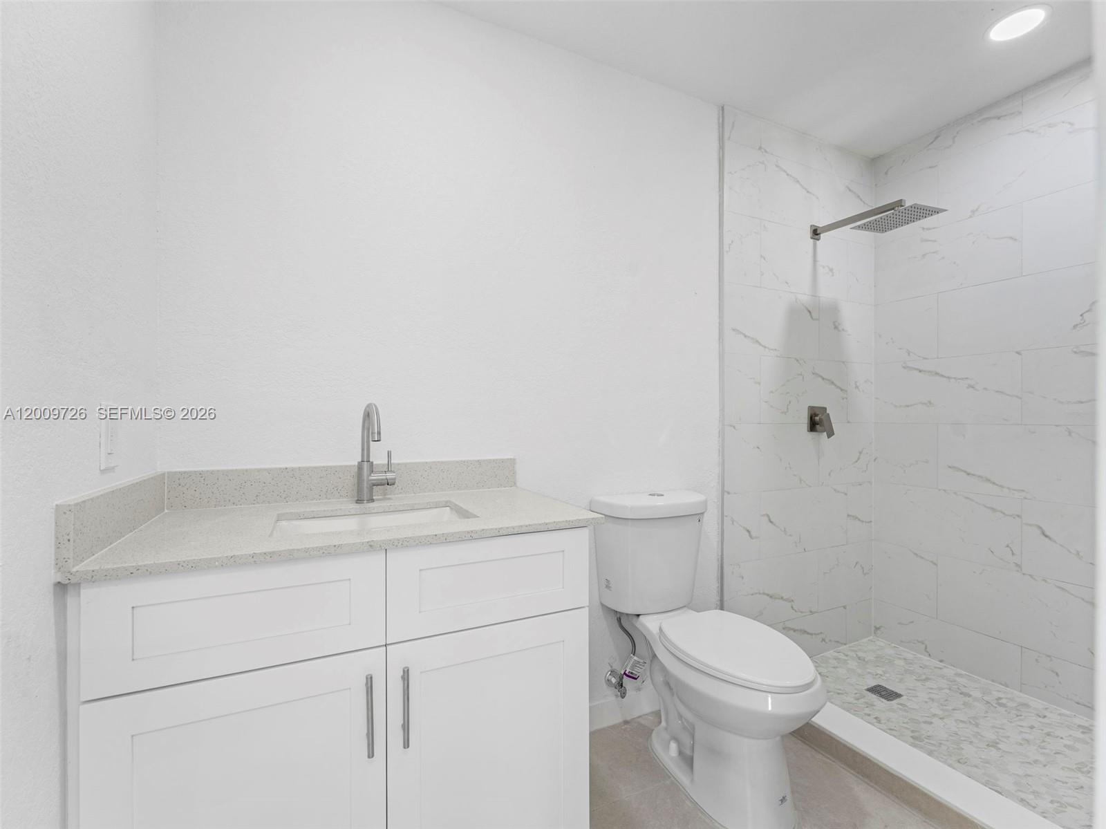 1370 West 29th Street, Unit A Hialeah, FL 33012 - Photo 10 of 16 a white toilet sitting next to a bathroom sink