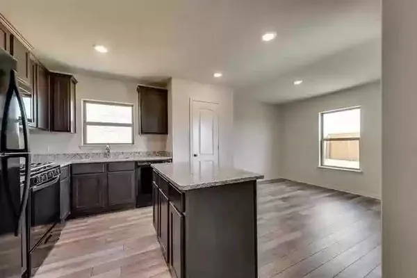 a bathroom with a sink a toilet a mirror and shower