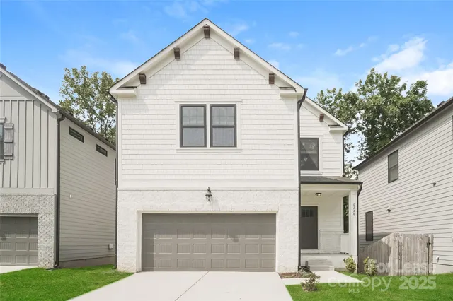 a front view of a house with garage