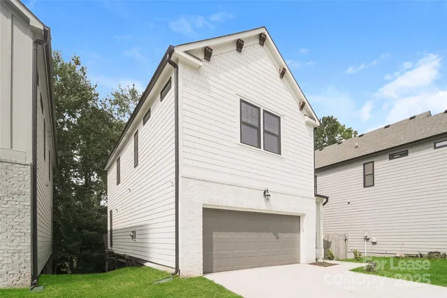 a view of house with backyard and trees in the background