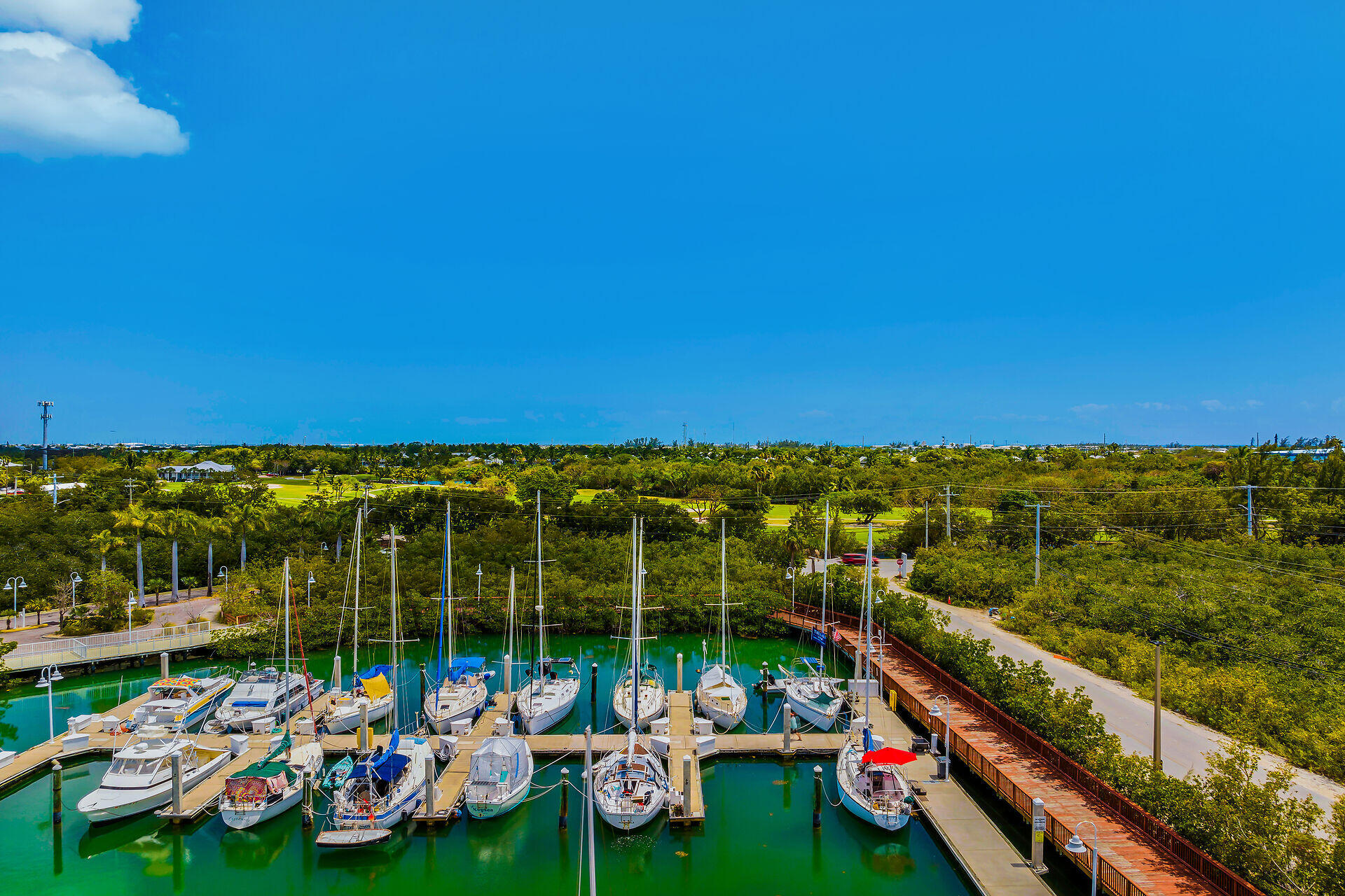 5555 College Road, Unit STARFISH 6 Key West, FL 33040 - Photo 17 of 21 a view of a balcony with chairs and table under an umbrella