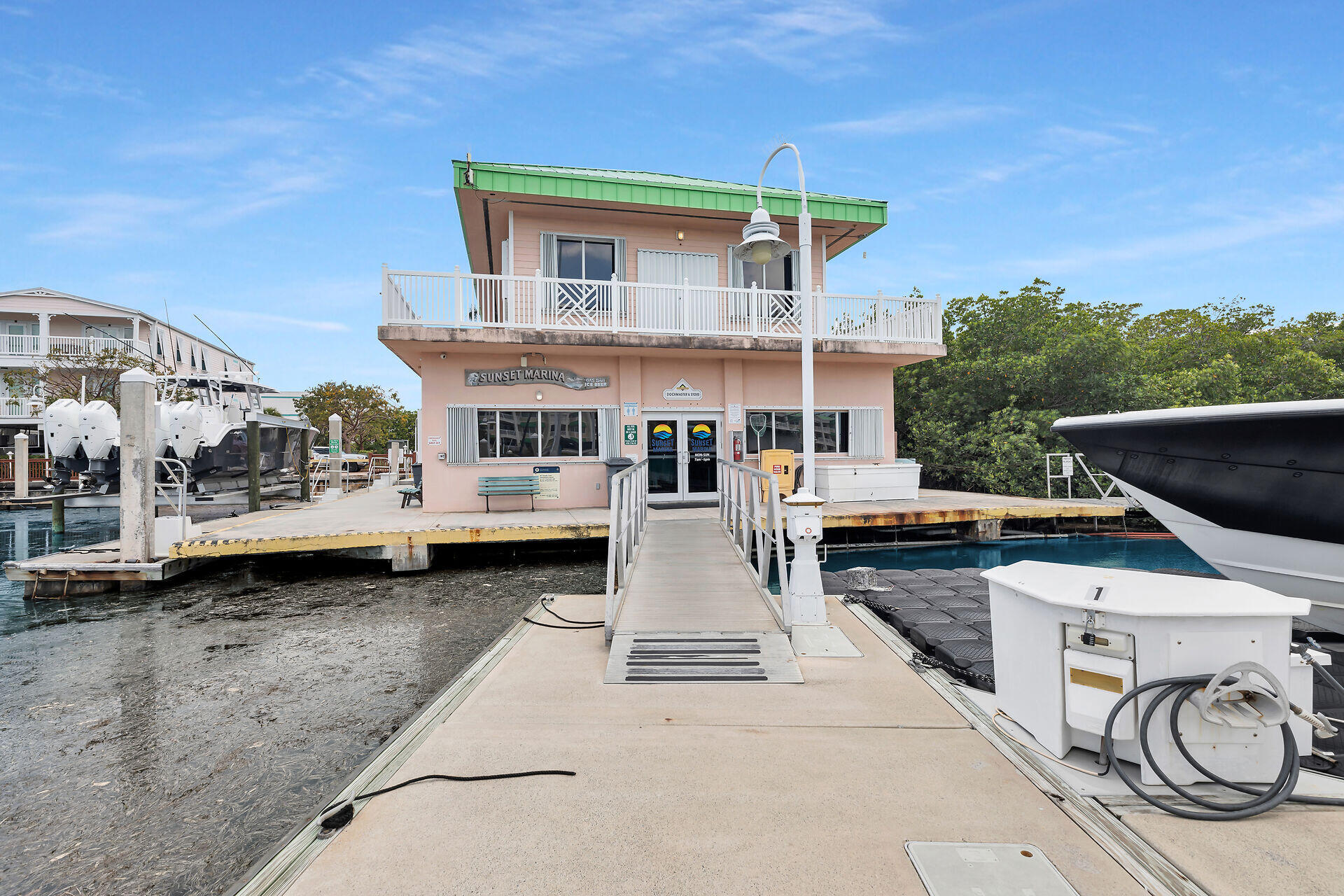 5555 College Road, Unit STARFISH 6 Key West, FL 33040 - Photo 19 of 21 a front view of a house with a garden and porch