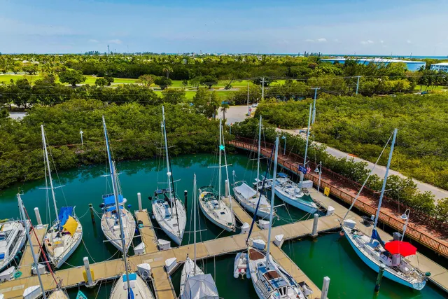 a kitchen with stainless steel appliances a stove a sink and white cabinets