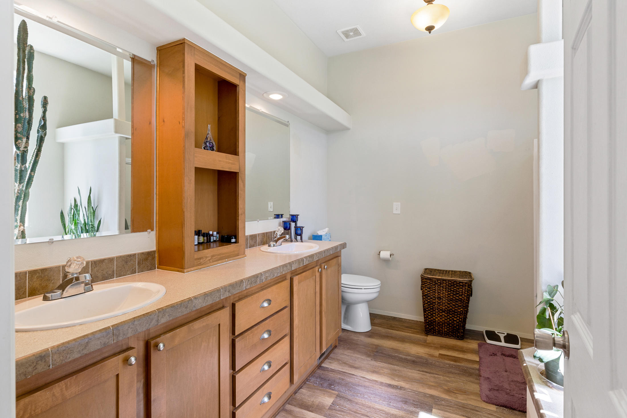 4550 Holland Loop Road Cave Junction, OR 97523 - Photo 19 of 39 a bathroom with a double vanity sink toilet and mirror