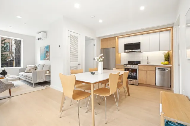 a view of kitchen with sink refrigerator dining table and chairs