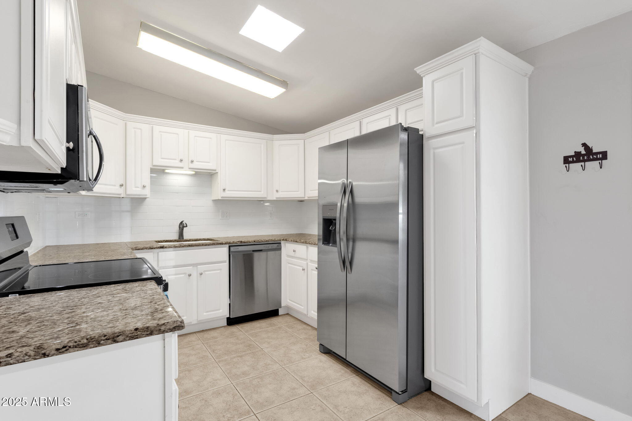 343 West Montecito Avenue Phoenix, AZ 85013 - Photo 15 of 39 a kitchen with stainless steel appliances granite countertop a refrigerator a sink and white cabinets