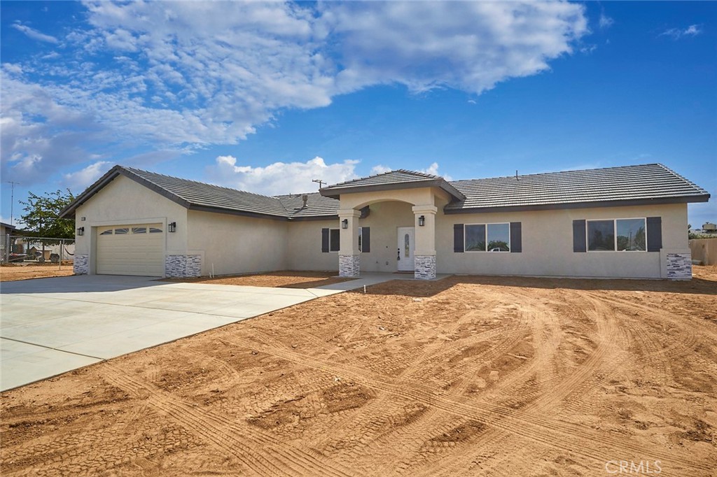 21240 Multnomah Road Apple Valley, CA 92308 - Photo 1 of 1 a front view of a house with a yard