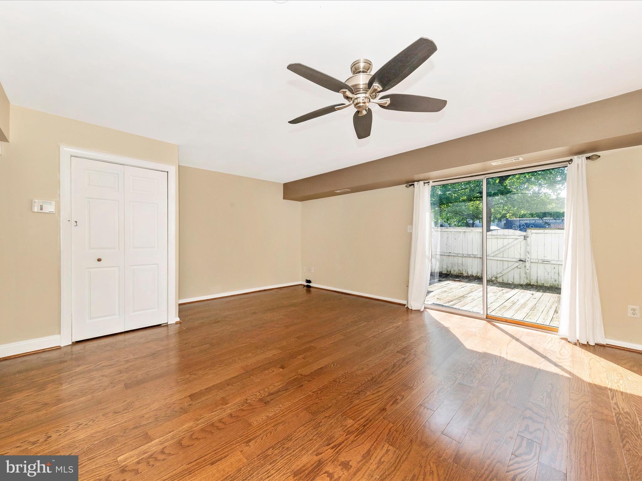 231 Coventry Square, Unit 231 Sterling, VA 20164 - Photo 12 of 40 a view of a livingroom with wooden floor and a ceiling fan