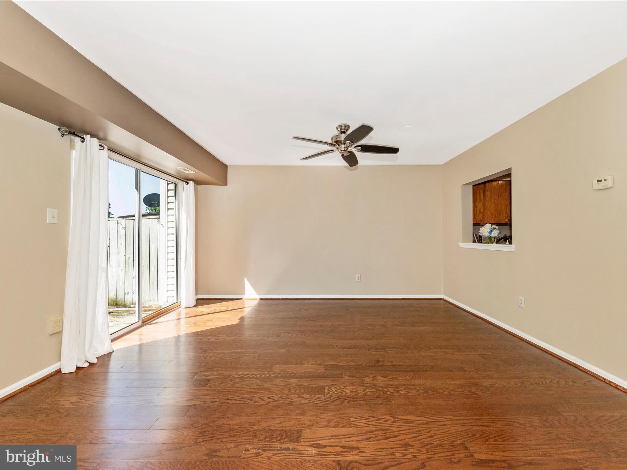 231 Coventry Square, Unit 231 Sterling, VA 20164 - Photo 15 of 40 a view of an empty room with a window and wooden floor