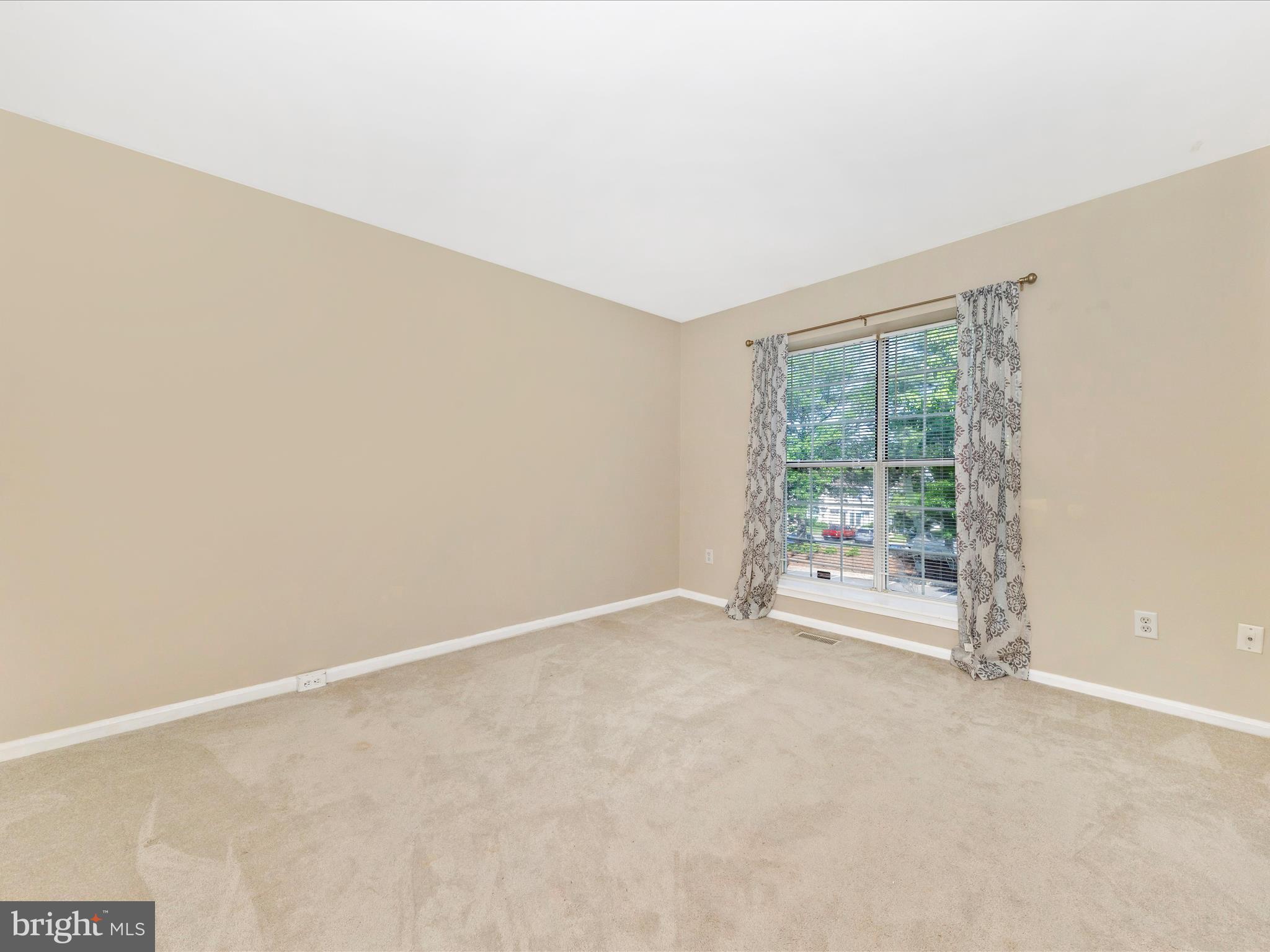 231 Coventry Square, Unit 231 Sterling, VA 20164 - Photo 24 of 40 an empty room with wooden floor and windows