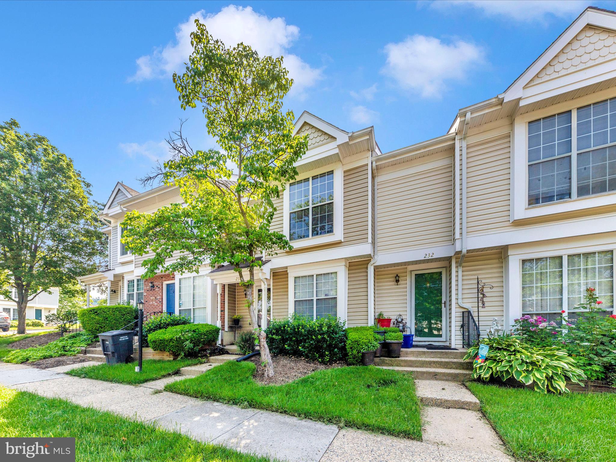 231 Coventry Square, Unit 231 Sterling, VA 20164 - Photo 32 of 40 a front view of a house with garden and trees