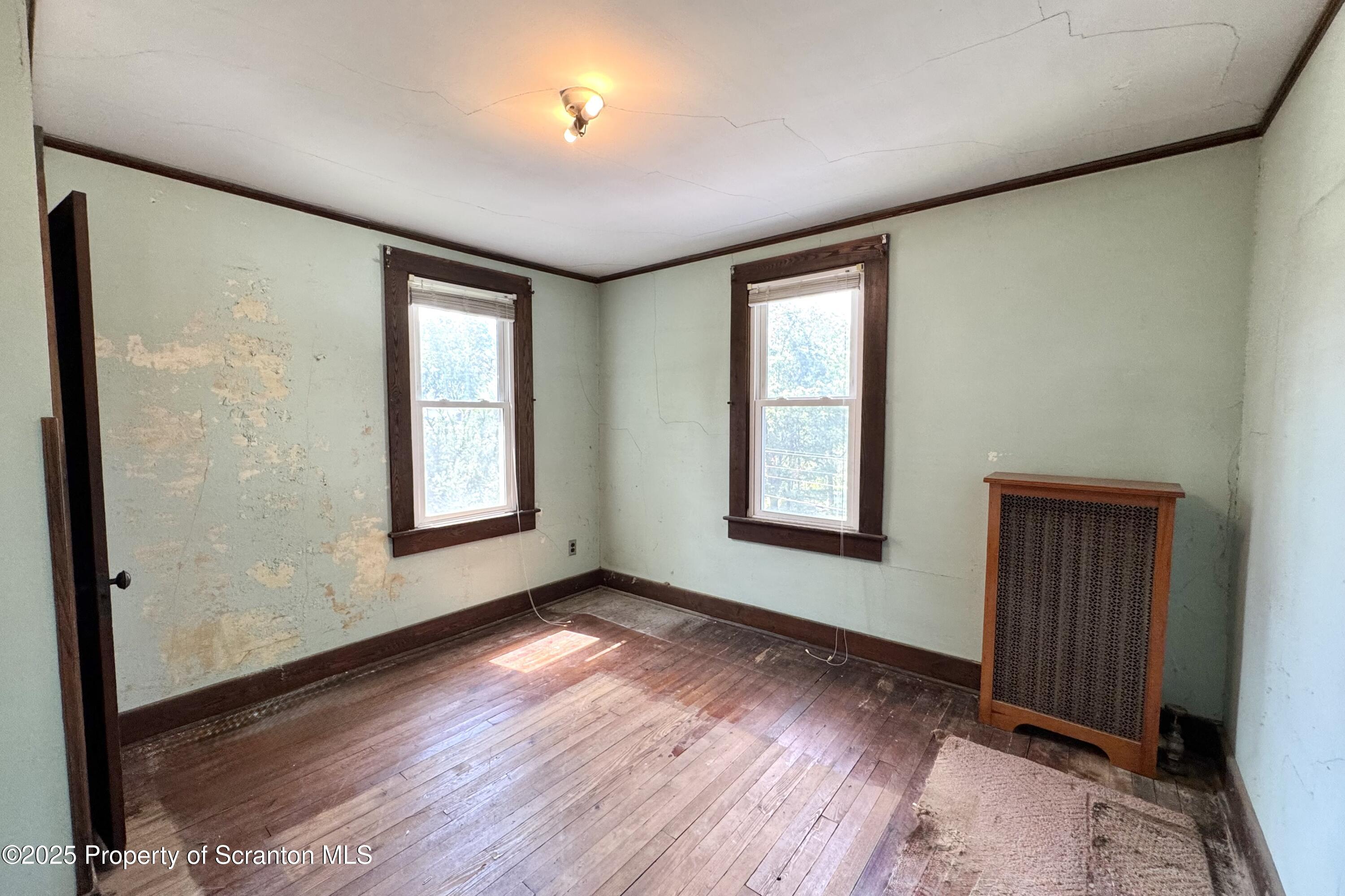413 Powell Avenue Clarks Summit, PA 18411 - Photo 14 of 31 an empty room with wooden floor and windows