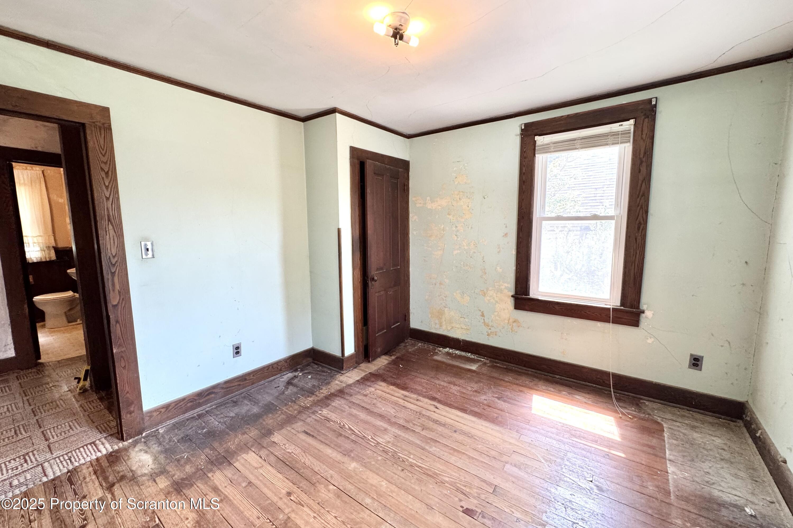 413 Powell Avenue Clarks Summit, PA 18411 - Photo 15 of 31 an empty room with wooden floor and windows