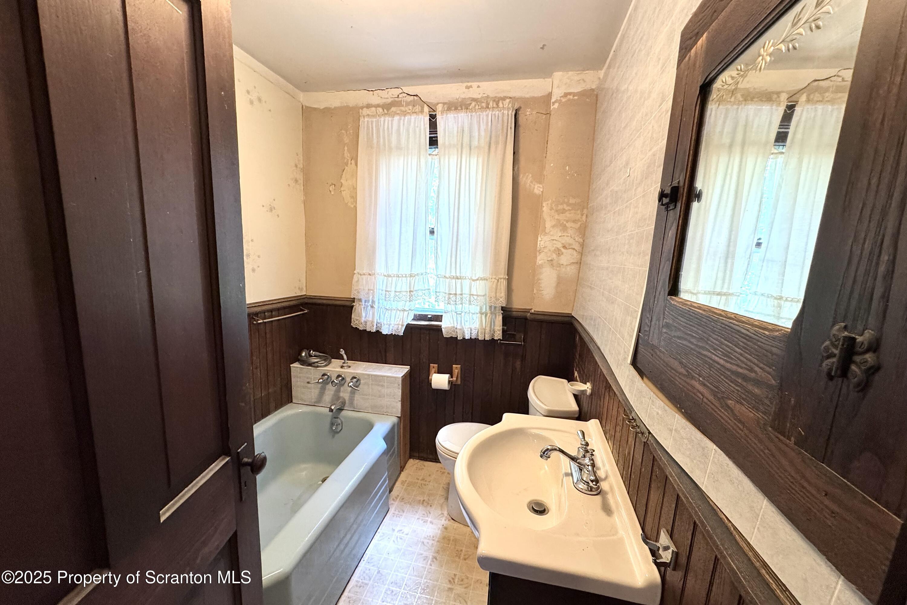 413 Powell Avenue Clarks Summit, PA 18411 - Photo 20 of 31 a bathroom with a tub sink and mirror