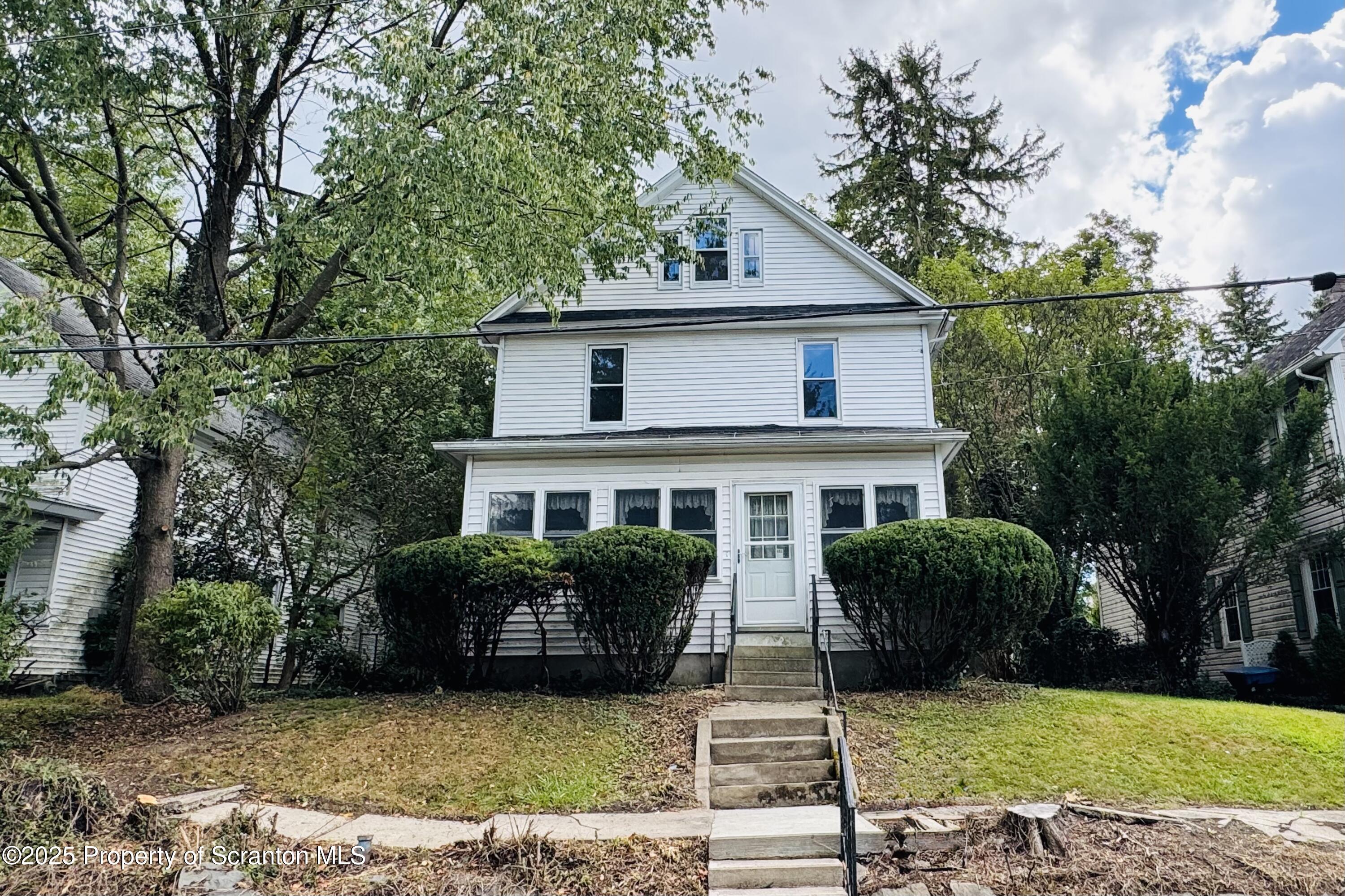 413 Powell Avenue Clarks Summit, PA 18411 - Photo 2 of 31 a front view of a house with garden