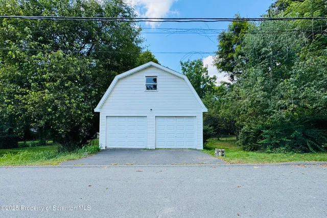 a view of a garage with a small yard
