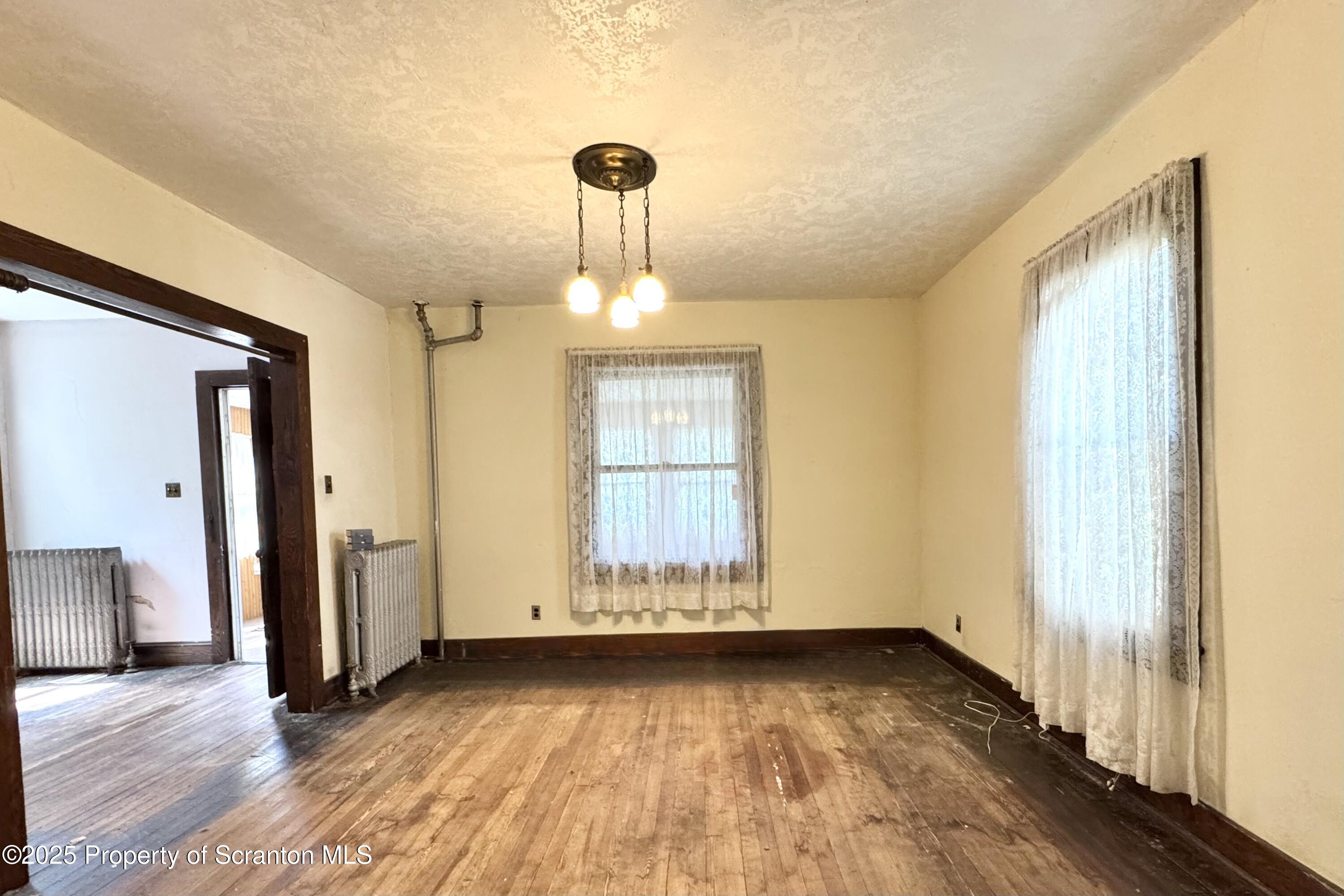 413 Powell Avenue Clarks Summit, PA 18411 - Photo 5 of 31 a view of empty room with wooden floor and fan