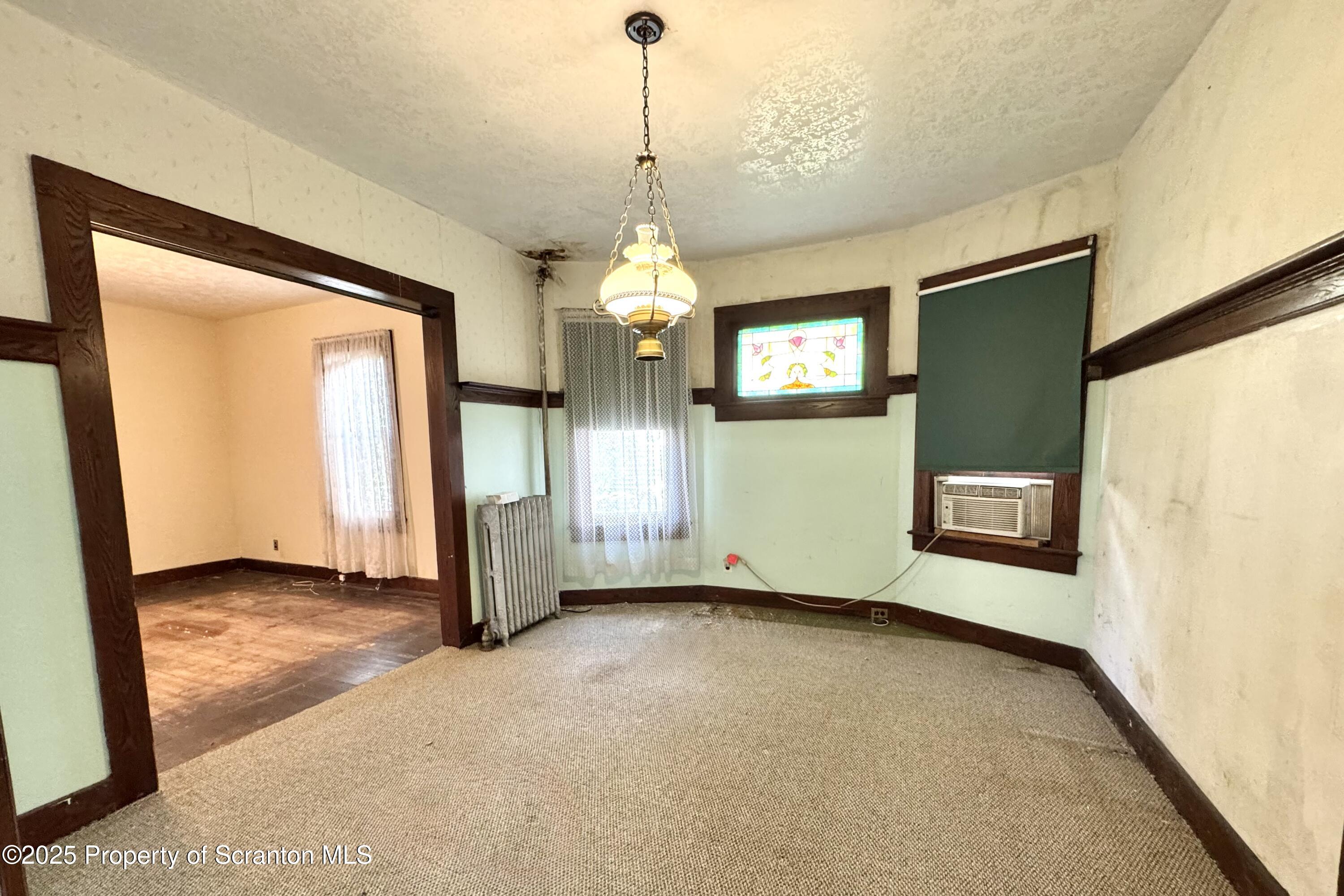 413 Powell Avenue Clarks Summit, PA 18411 - Photo 7 of 31 a view of an empty room with window and stairs