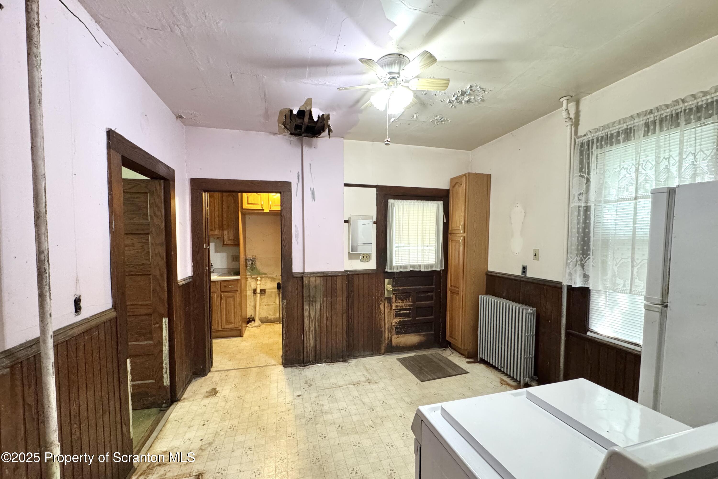 413 Powell Avenue Clarks Summit, PA 18411 - Photo 10 of 31 a bedroom with a bed and a chandelier