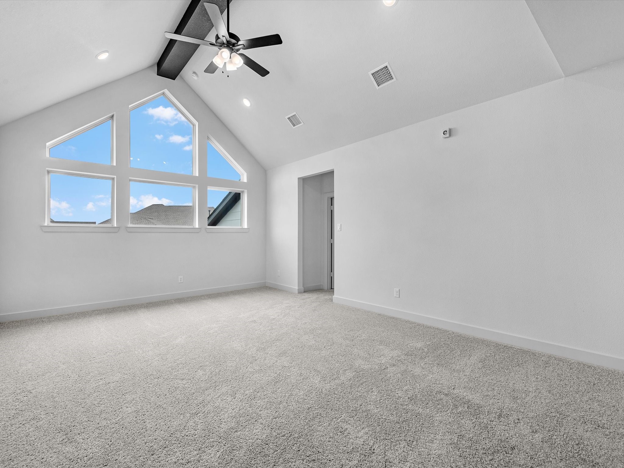 8915 Acropolis Lane Manvel, TX 77578 - Photo 19 of 32 an empty room with a ceiling fan and windows