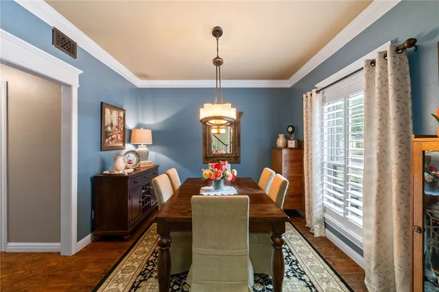 a living room with furniture chandelier and a large window