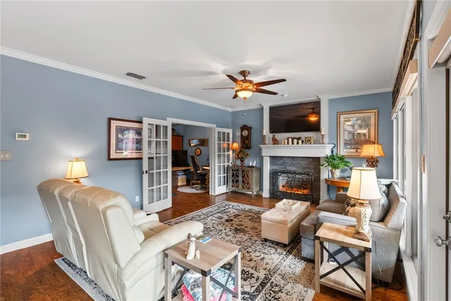 a living room with furniture a fireplace and a flat screen tv