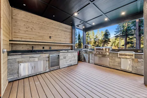 a large kitchen with stainless steel appliances granite countertop a stove and cabinets