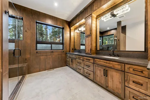 a bathroom with a double vanity sink and mirror