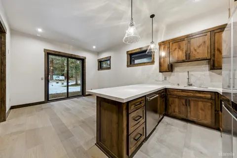 a kitchen with stainless steel appliances granite countertop a stove and a sink