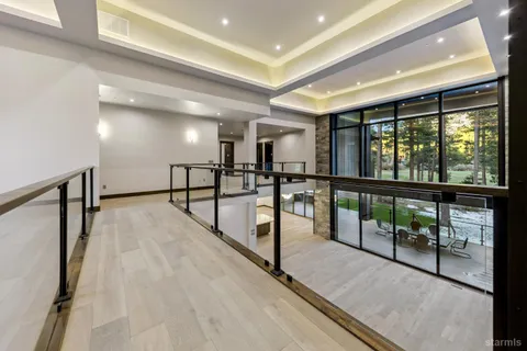 a view of a lobby with floor to ceiling windows and a chandelier