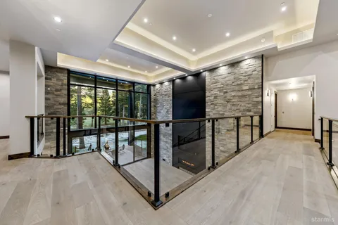 a view of an empty room with wooden floor