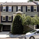 a front view of a house with plants