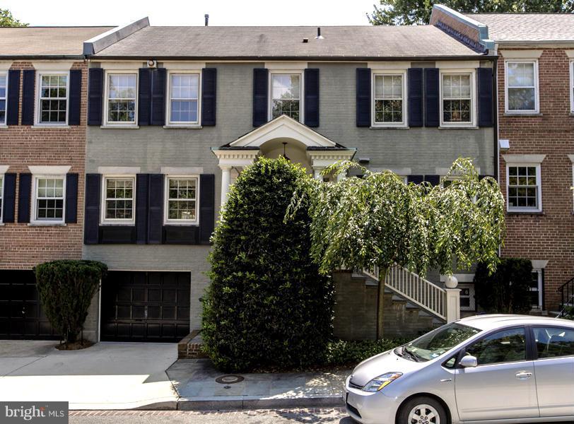 a front view of a house with plants