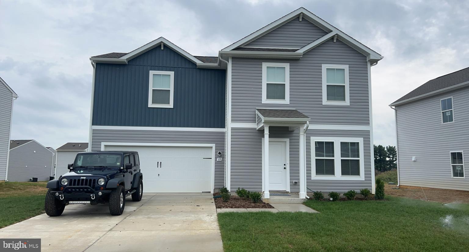 a front view of a house with a garden and plants