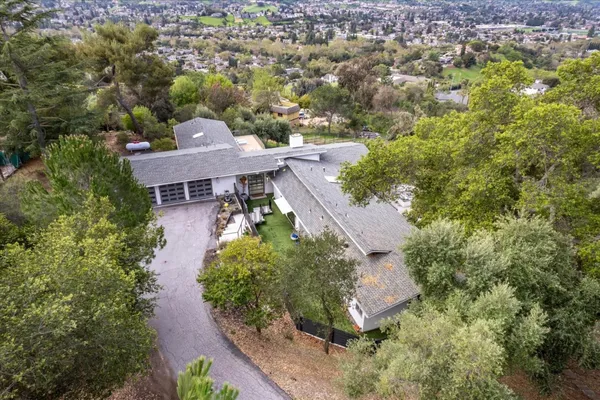 an aerial view of residential house with green space