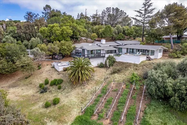 a dining room with furniture and floor to ceiling window
